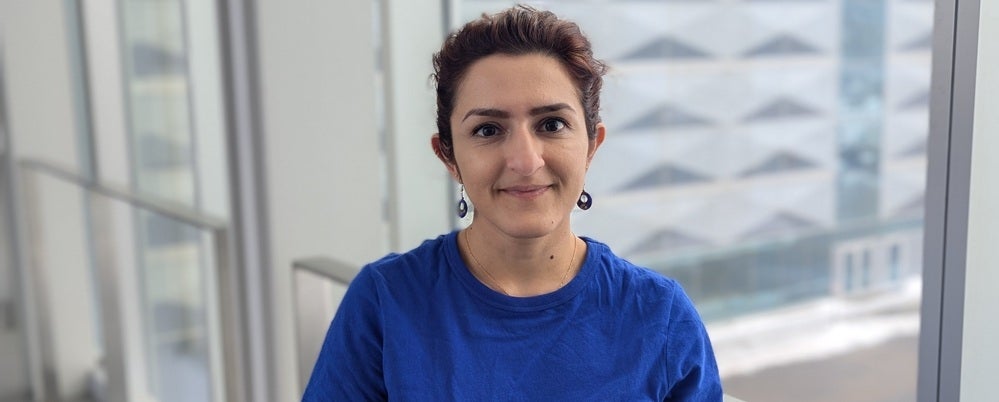a woman in a blue t-shirt smiling