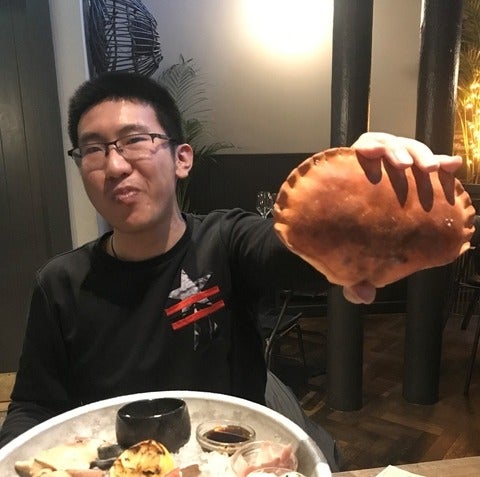 Shuji Chang holding a crab