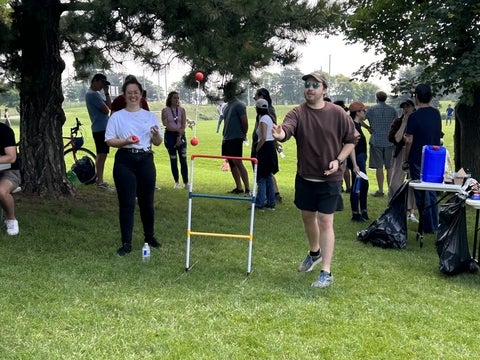 Chemistry graduate students playing games outside.