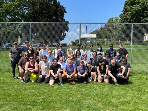 Chemistry graduate students posing on field.