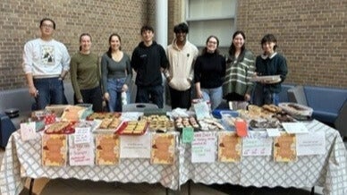 Students posing with their bake sale offerings.