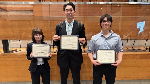 Percy Luk, Grace DelMistro, and Daniel Wang holding their award certificates at the conference.