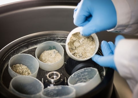 A powder sample being pulled from a centrifuge.
