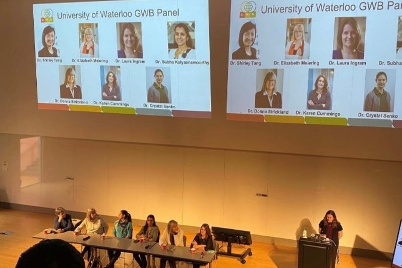 Students watching a presentation in a lecture hall.
