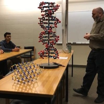 Chris Bingleman with students and molecule models.