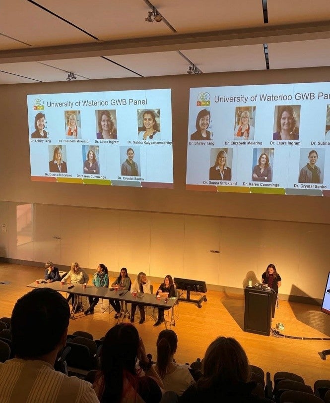 Students watching a presentation in a lecture hall.