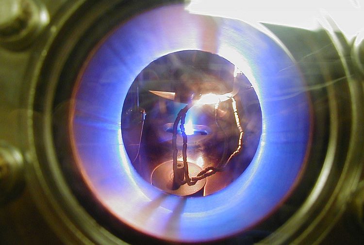 metal box with blue flame circle and burner in centre
