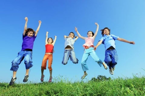 Kids jumping on grass