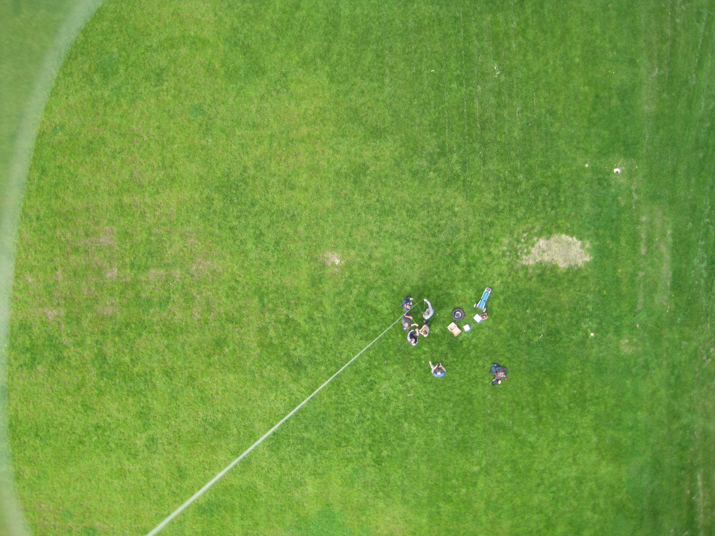 Aerial shot of the team reeling in the balloon.