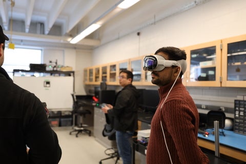 student wearing vr headset, in computer lab