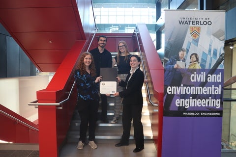 TEAM PHOTO, HOLDING AN AWARD CERTIFICATE