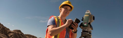 Woman in hard hat collecting data
