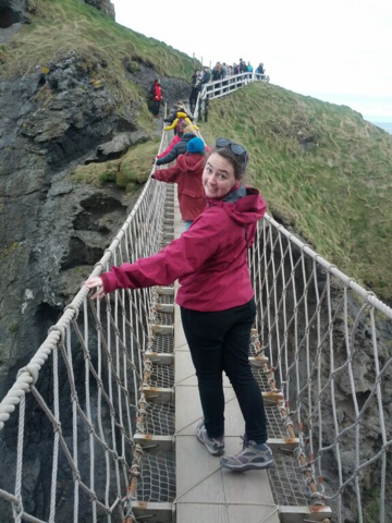 Student crossing a suspension bridge in Northern Ireland