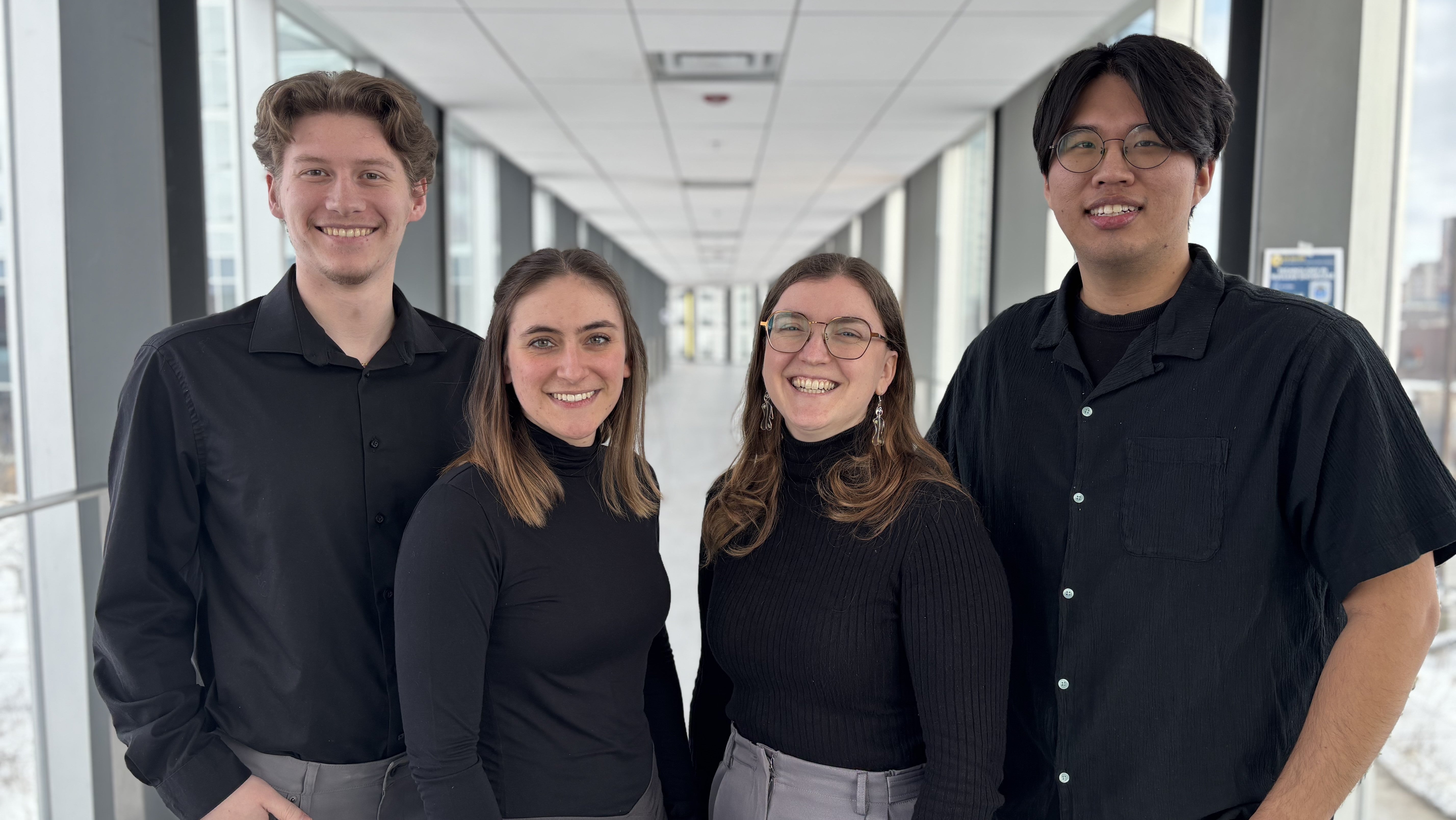 team photo of 4 students in black, two females two males