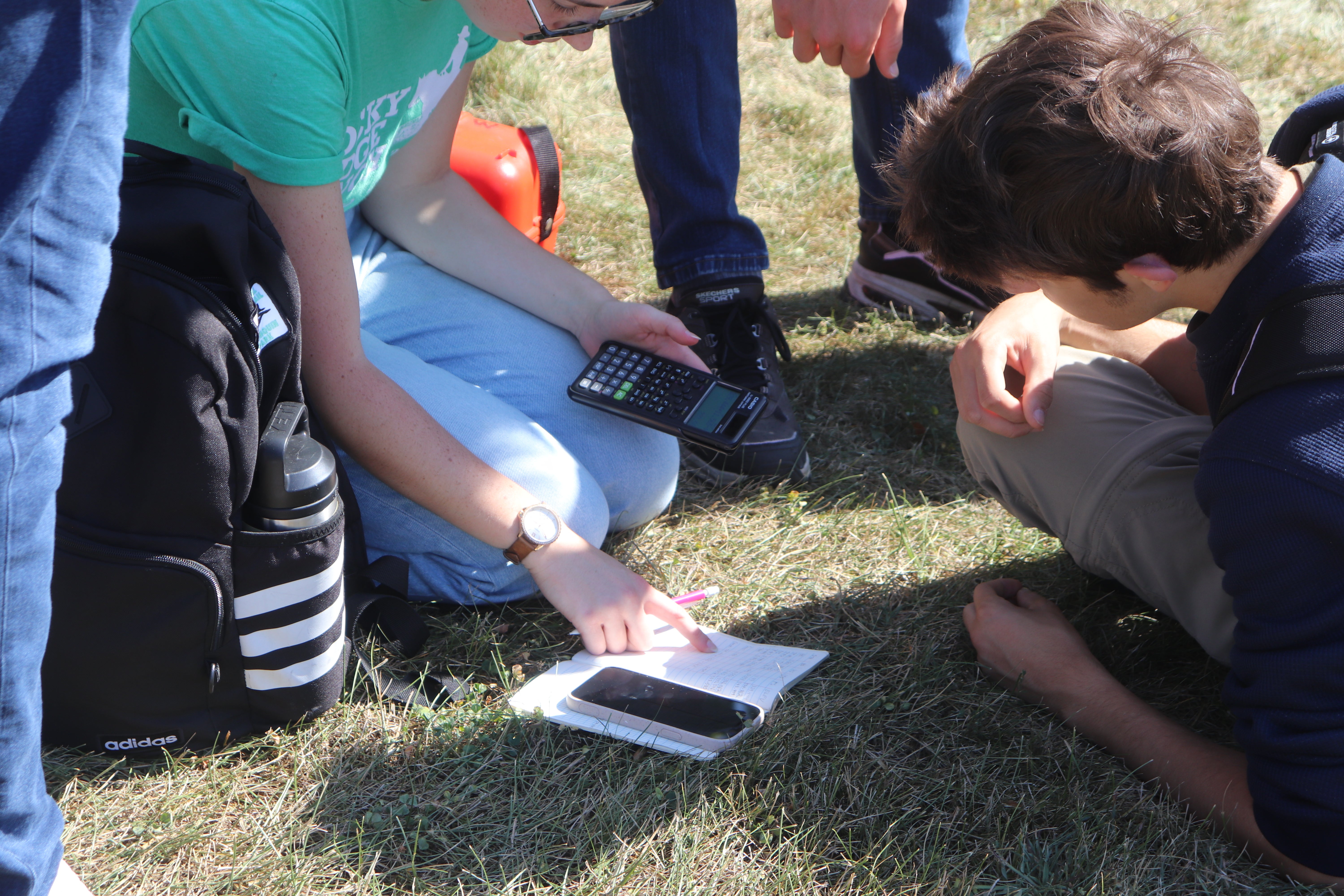 2 students recording some work in a note book