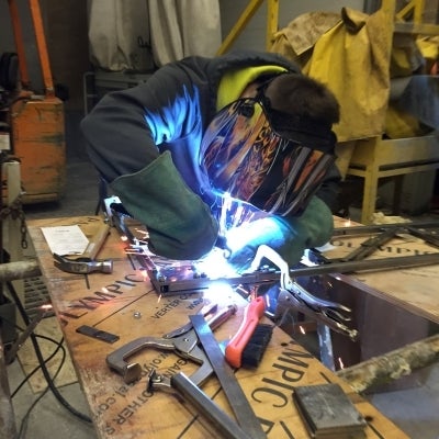 Student welding steel