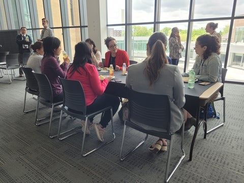 Participants discussing at a table over the networking lunch.