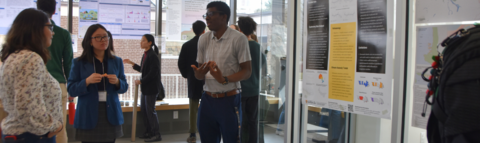 Students gathered around a poster at the climate con