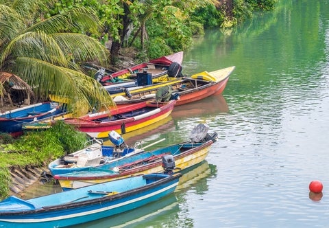 Colourful boats docked on river bank.