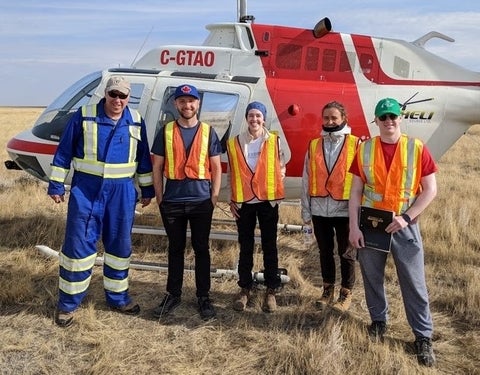 Waterloo researchers with a helicopter used for airborne hyperspectral measurements of methane. From left are Dr. Kyle Daun, Michael Nagorski, Augustine Wigle, Dr. Paule Lapeyre and Daniel Blackmore.