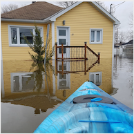 kayak in flooded waters in front of house