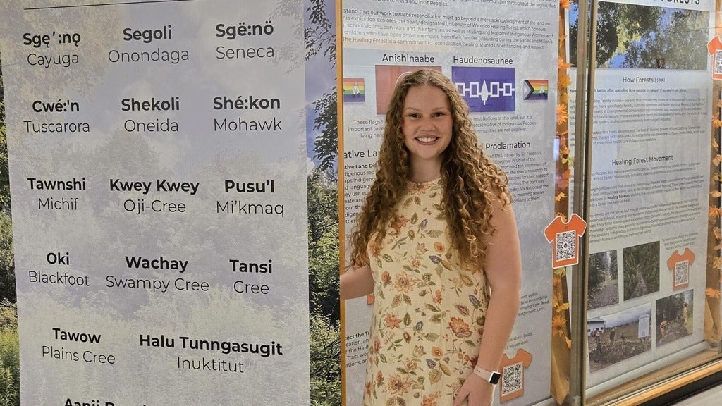 Sophia Armstrong standing next to a list of first nations groups