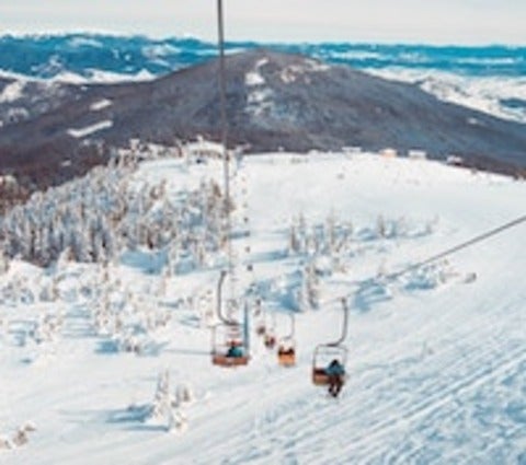 Ski lift overtop snowy mountains