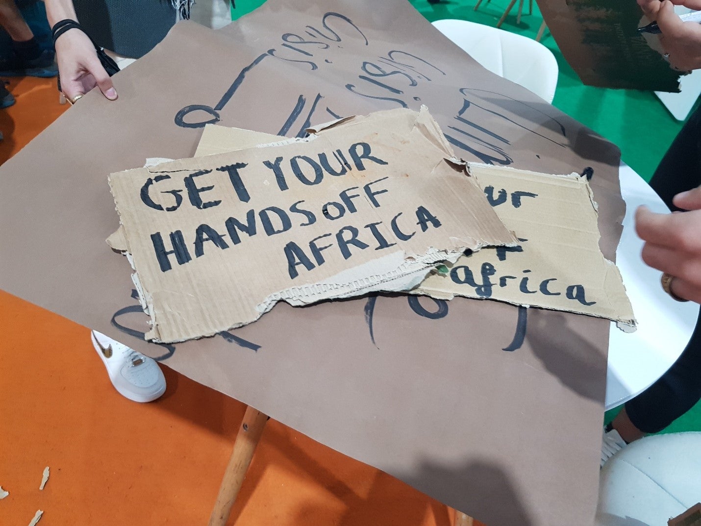 Protest sign that says "get your hands off Africa!"