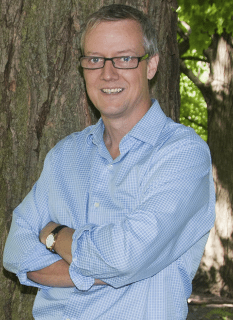 Neil Craik standing with folded arms