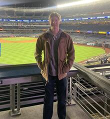 Nathan posing at the Rogers Centre with the baseball field in the background.