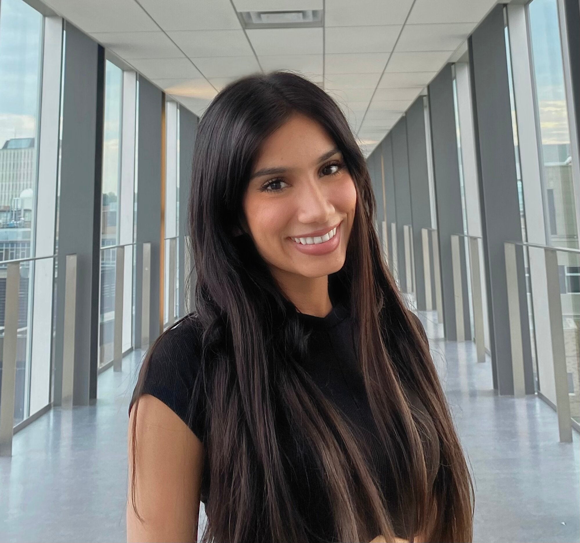 A photo of Esha smiling on the Engineering bridge at the University of Waterloo.