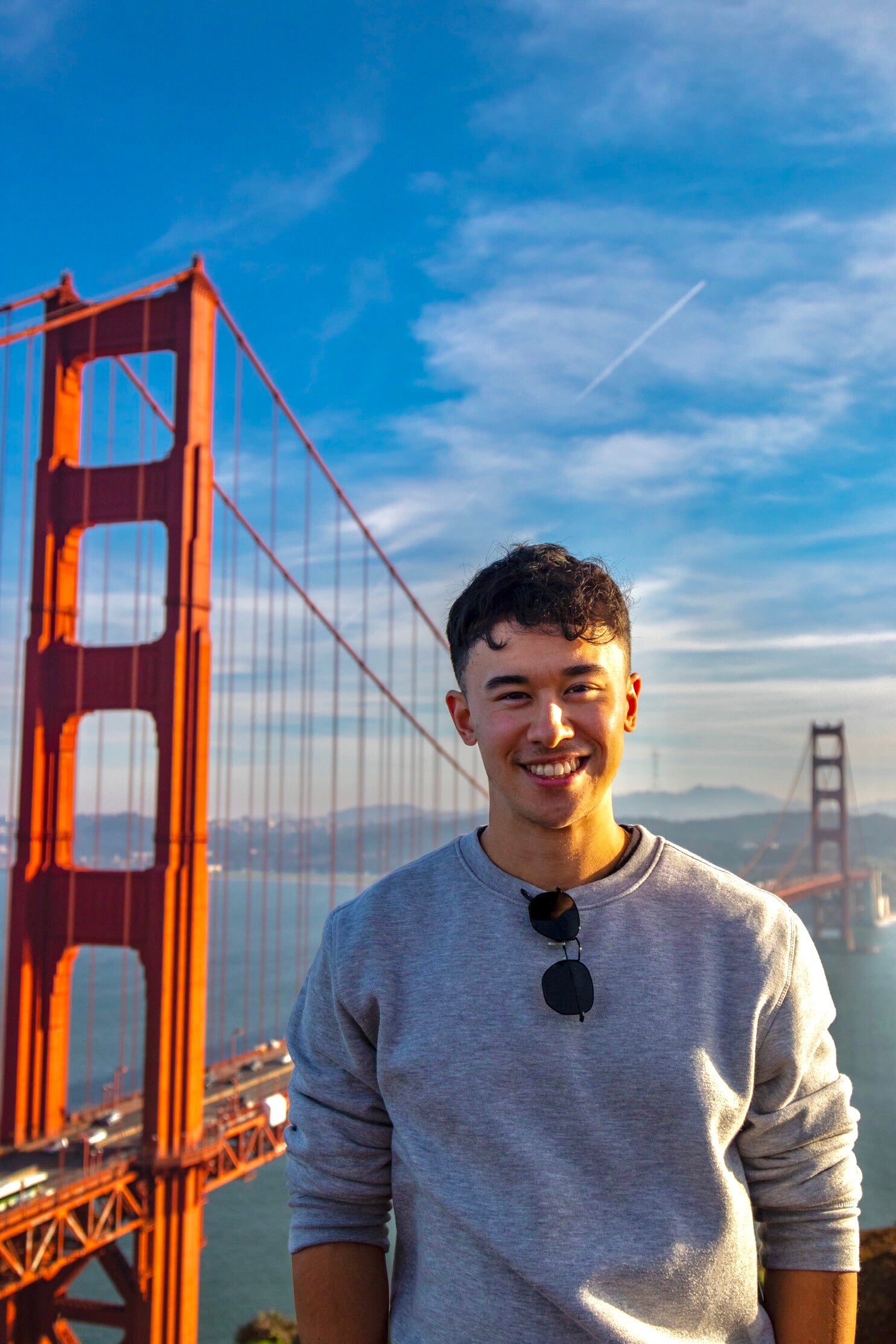 A photo of Brandon standing by the Golden Gate Bridge in San Francisco, California.