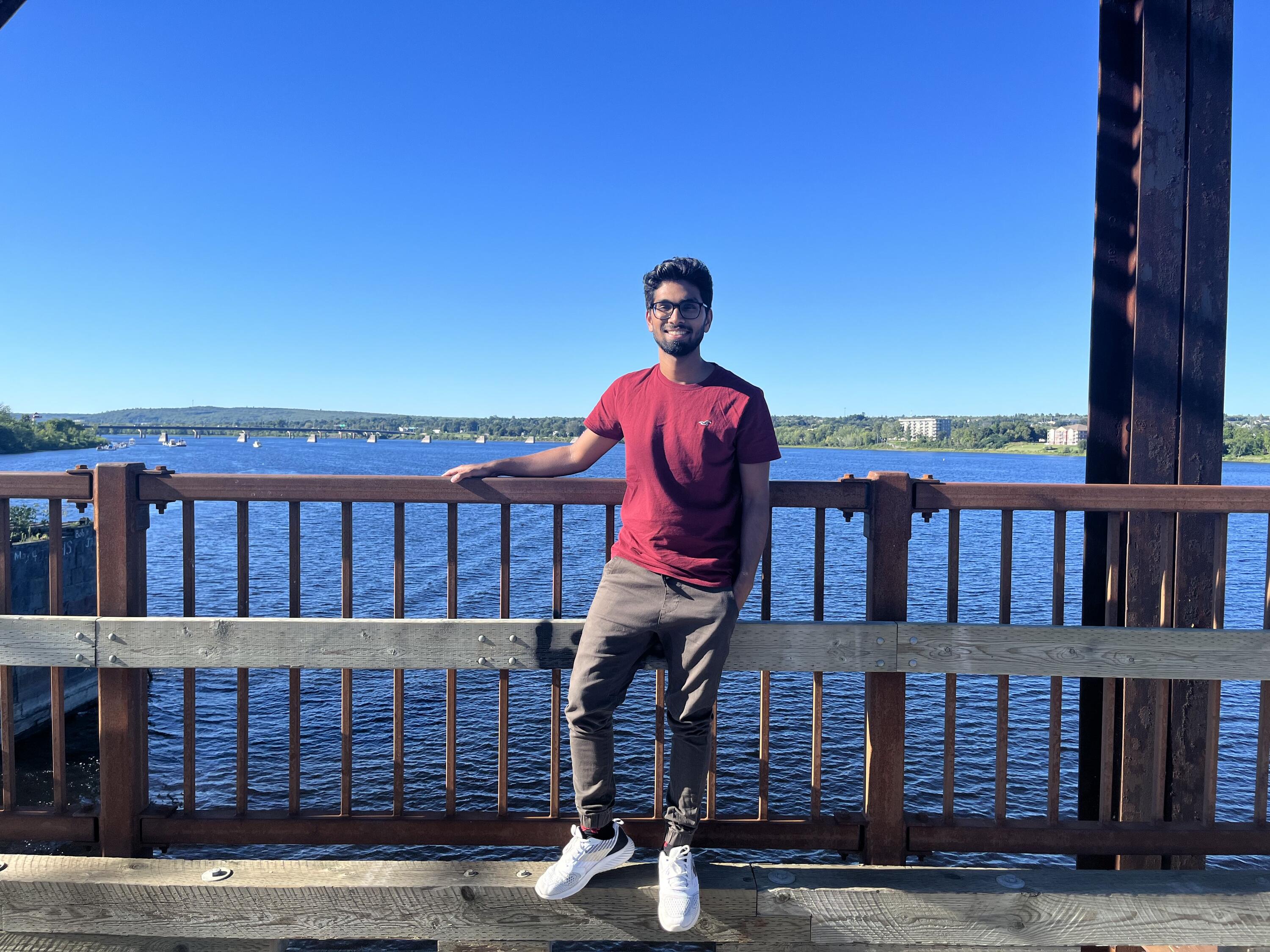 Saurav standing in front of a water body 