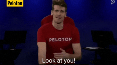 GIF of a man riding a stationary bike with the caption, &quot;Look at you! You're a pro!&quot; and the credit tag &quot;Peloton&quot;