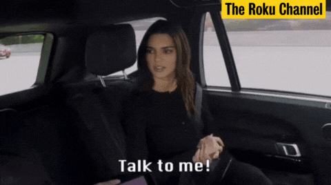 GIF of Kendall Jenner speaking and moving her hand fast, with the caption &quot;Talk to me!&quot;, and the credit tag &quot;The Roku Channel&quot; located on the top right.