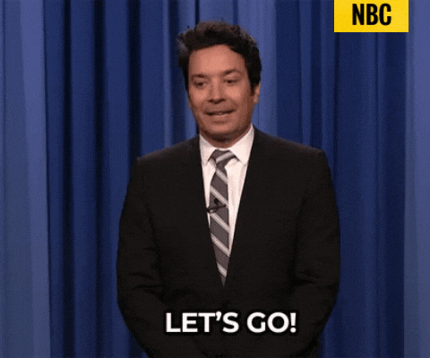 GIF of Jimmy Fallon speaking and moving his hand fast, with the caption &quot;Let's go!&quot;, and the credit tag &quot;NBC&quot; located on the top right.