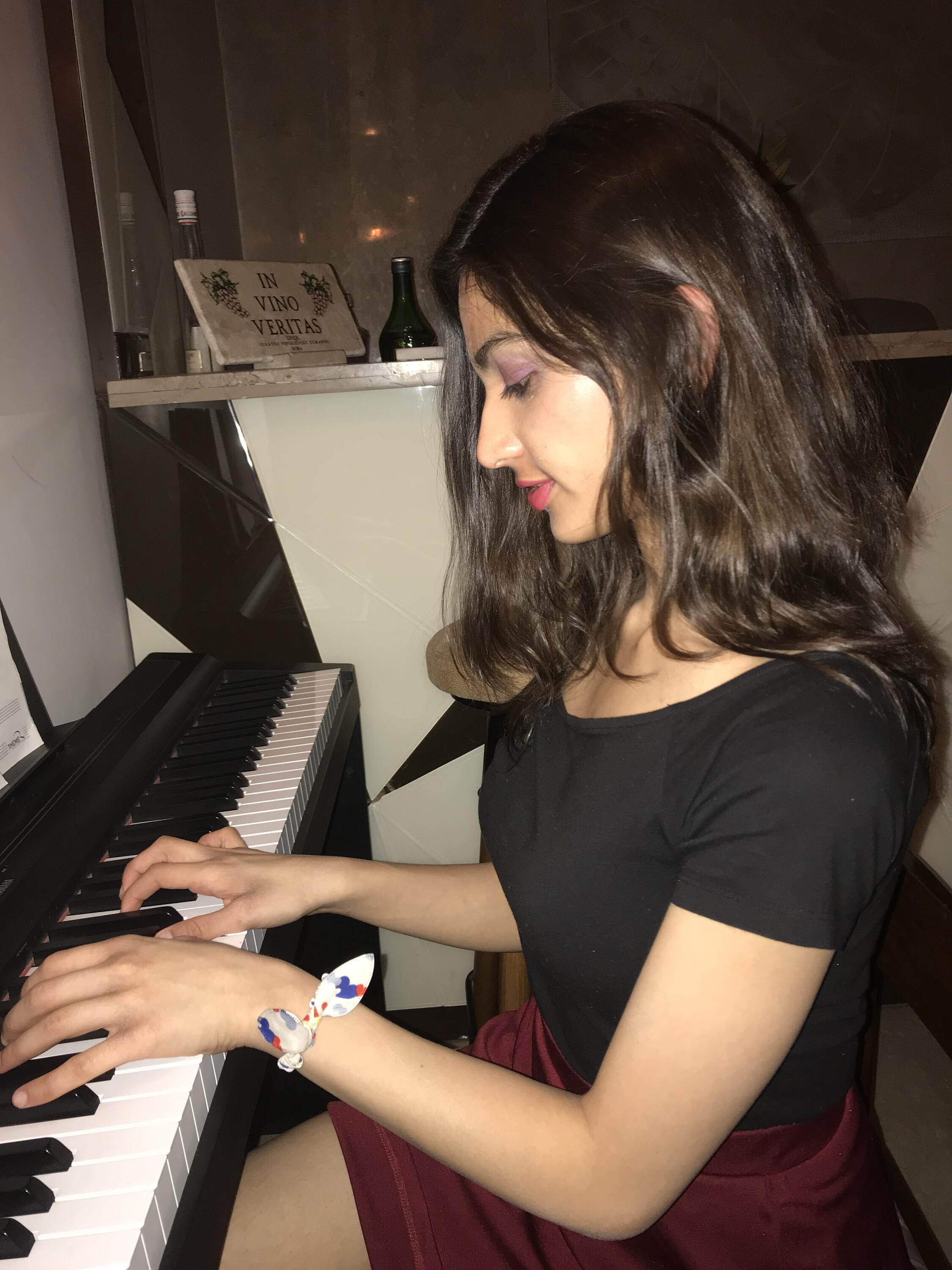 A photo of Manvi playing the piano.