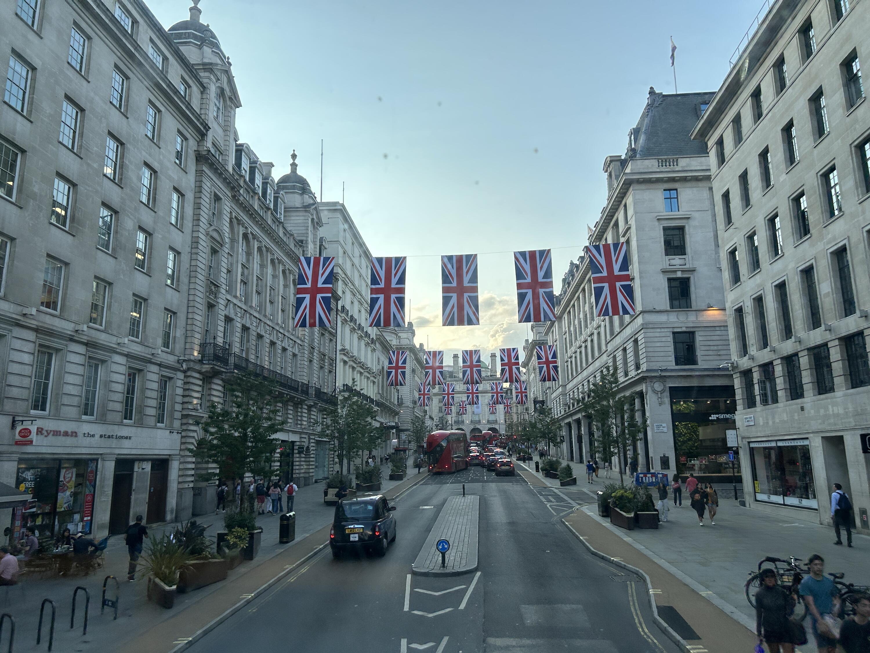 London, England with the flag of the United Kingdom hung over top of the streets. 
