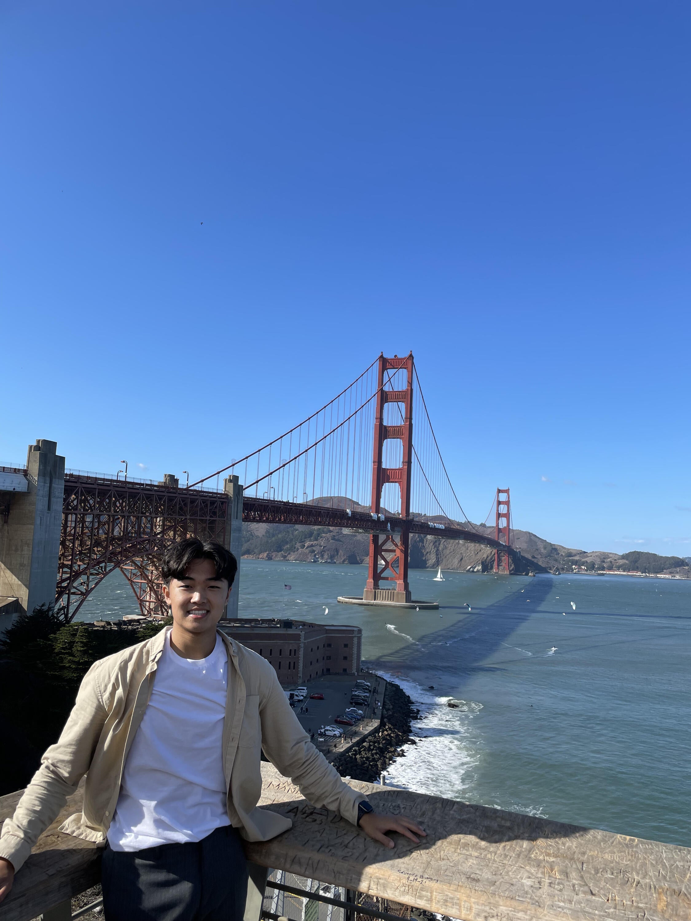 Photo of Jonny smiling outside, in front of the Golden Gate Bridge 