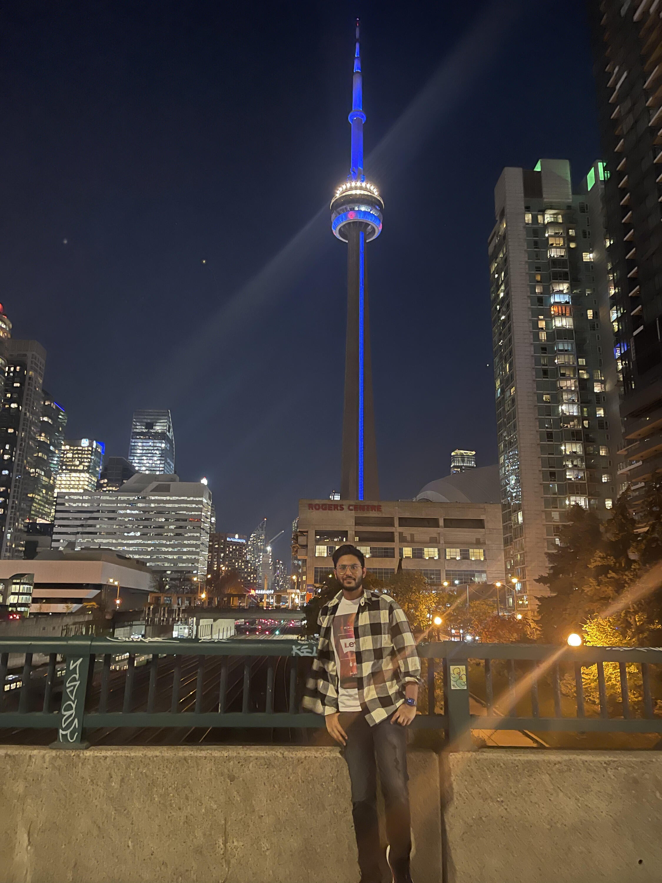 Arnav in front of the CN tower at night.
