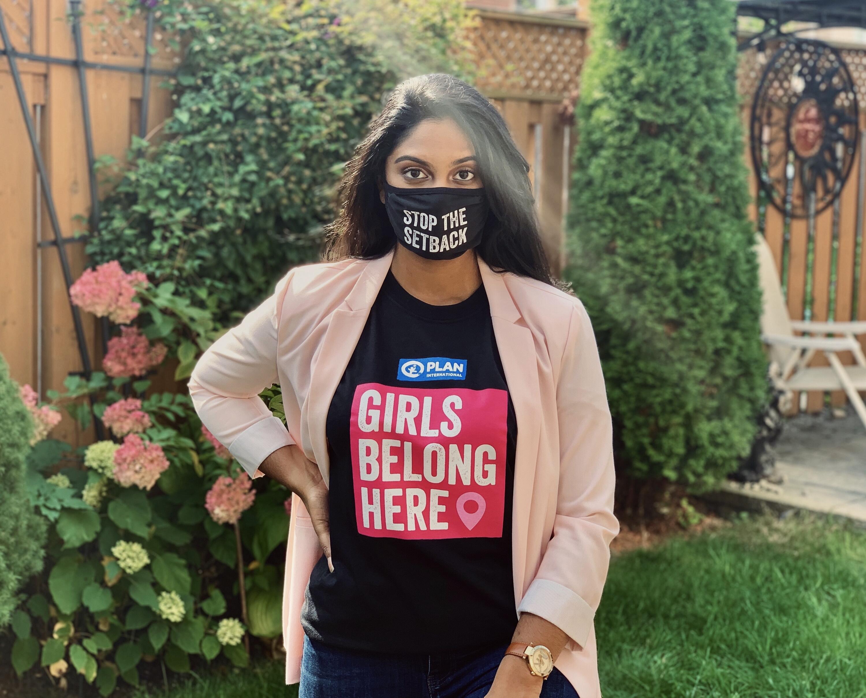 Sophia wearing a shirt that says 'girls belong here' a mask that reads 'stop the setbacl'.
