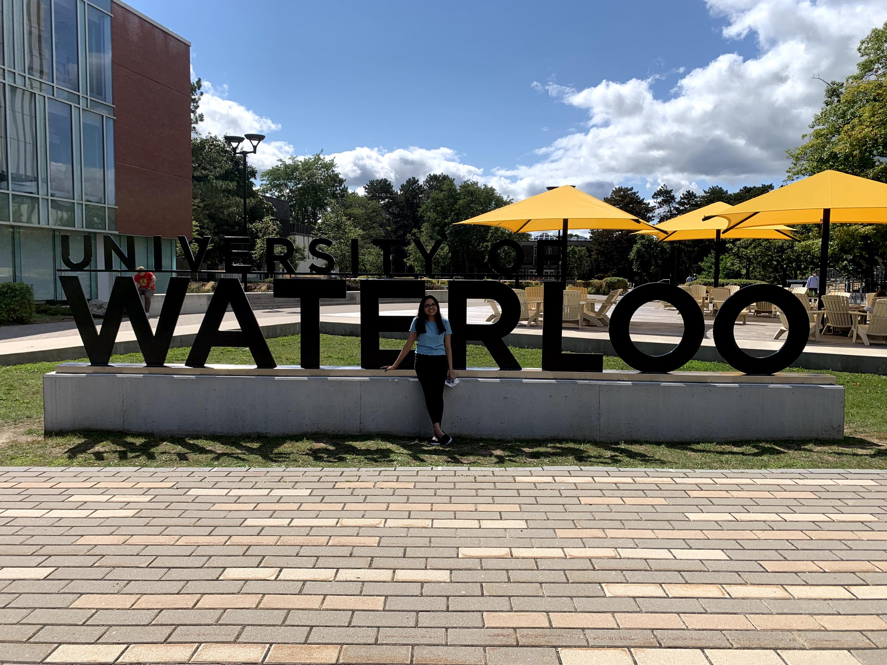 Dhruvi standing infront of the waterloo sign 