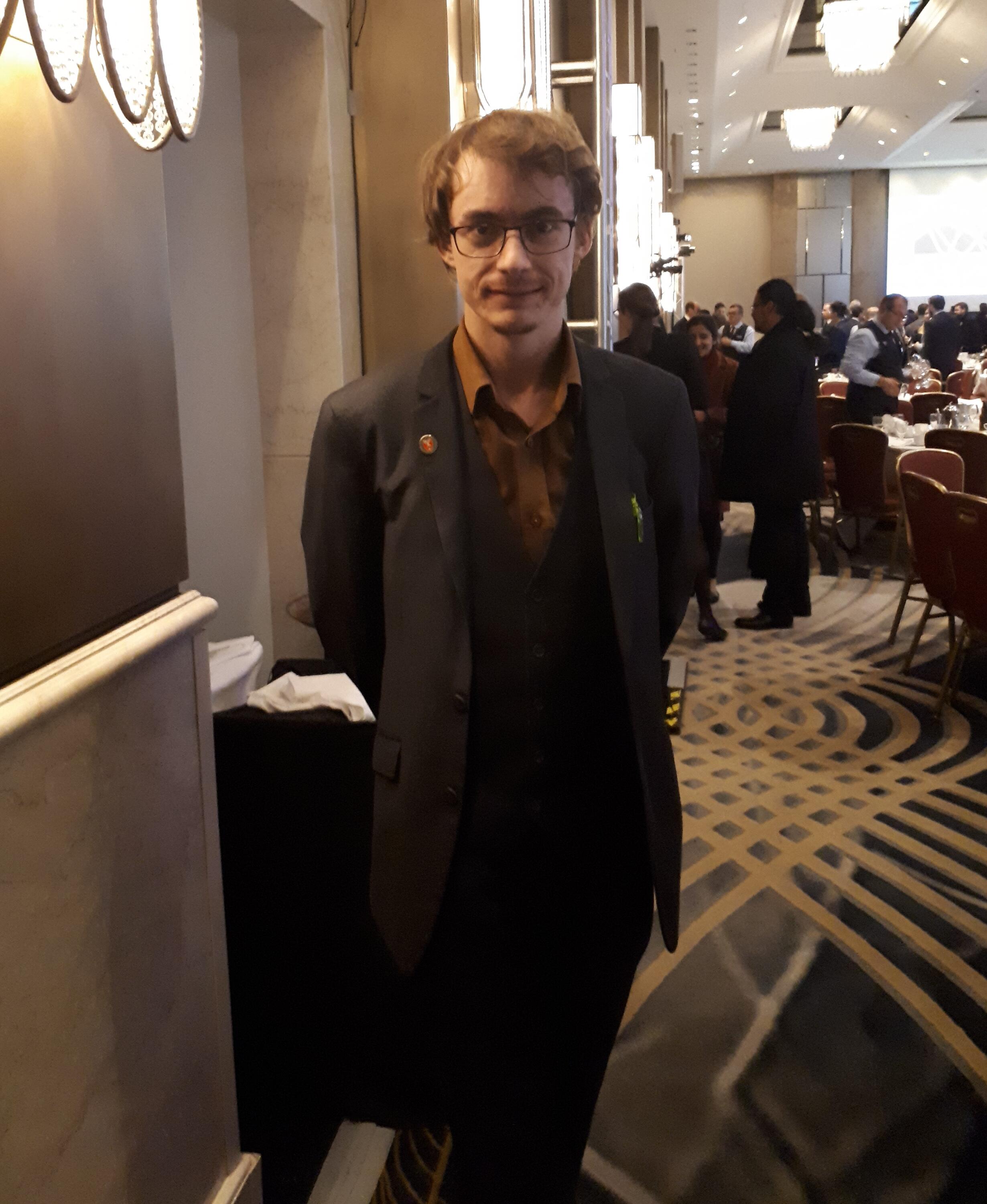 Photo of Matt standing in a banquet hall