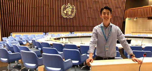 John Kim standing inside the World Health Organization buildng