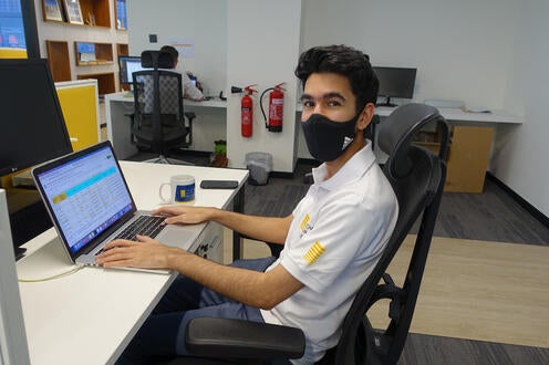 Ayman Gostar working at his desk at Yellow Door Energy