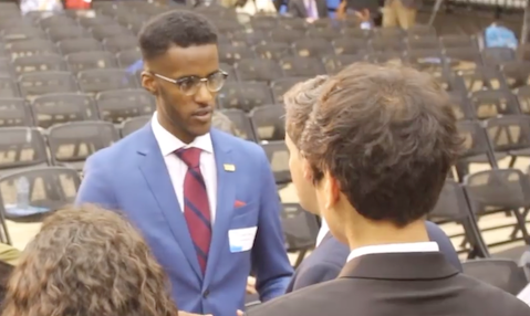 Photo of Joseph standing and talking with someone, when he was awarded the &quot;Dave Black Award for Excellence in Innovation and Entrepreneurship&quot; in SHAD 2017