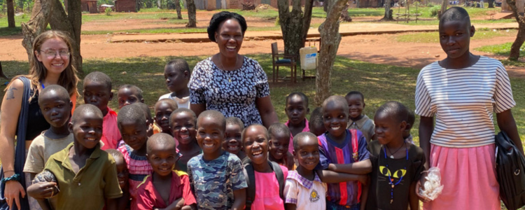Samantha Kremer with women and children in Uganda