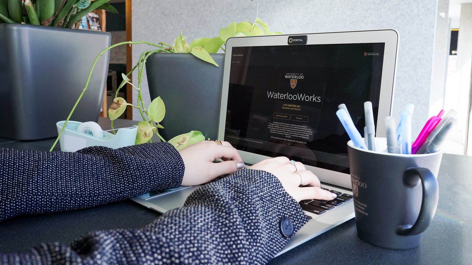 hands on laptop screen on "waterloo works"