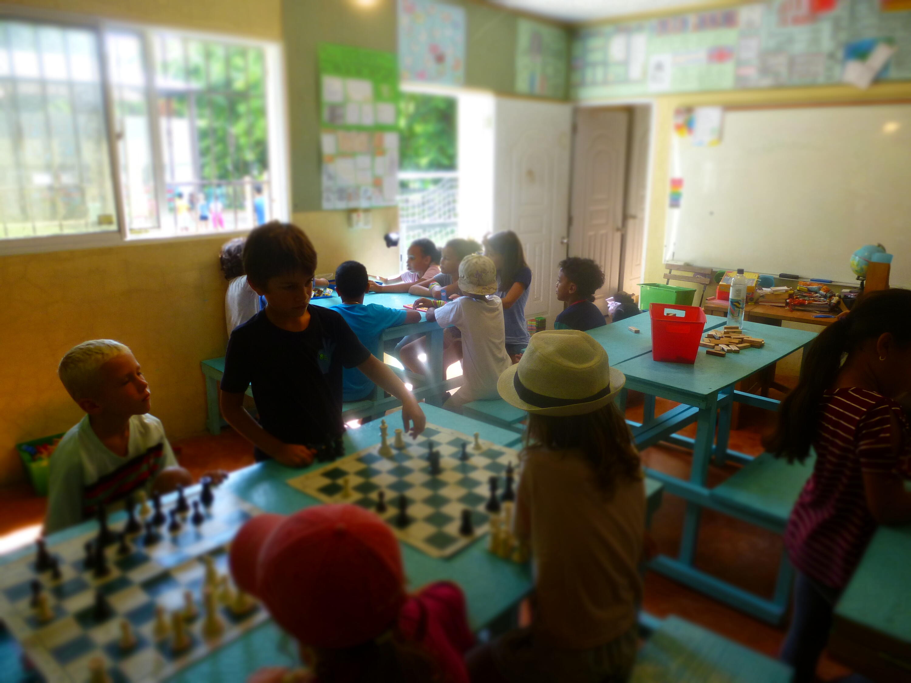 Children playing chess and other board games