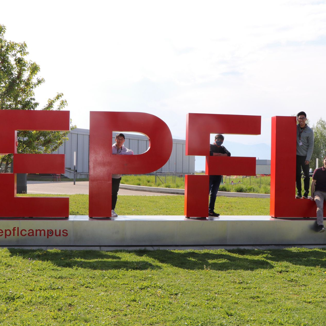 picture of Andrew standing in front of an EPFL logo